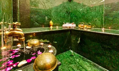 a bathroom with a fountain and a sink with flowers at RIAD Miel & Une Nuit in Marrakech