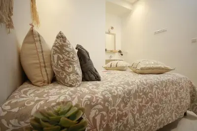a bedroom with a bed with pillows and a plant at RIAD Miel & Une Nuit in Marrakech