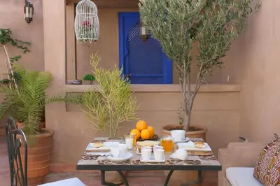 a table with food and drinks and oranges on it at Riad Baba Ali & Spa in Marrakech
