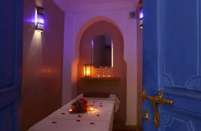 a room with a bed with lights and a mirror at Riad Baba Ali & Spa in Marrakech