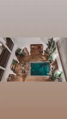 an overhead view of a house with a swimming pool at Riad Baba Ali & Spa in Marrakech