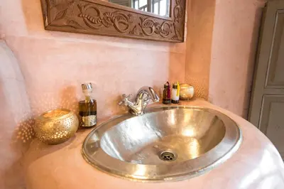 a silver sink in a bathroom with a mirror at Riad Hissan in Marrakech
