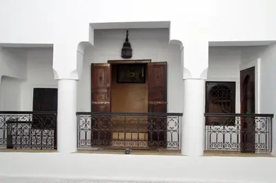 a front porch of a house with a wooden door at Riad Mina in Marrakech