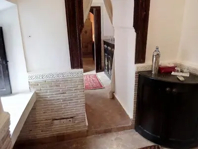 a hallway of a house with a brick wall at Riad Mina in Marrakech