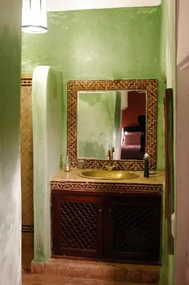 a bathroom with a sink and a mirror at Riad Mina in Marrakech