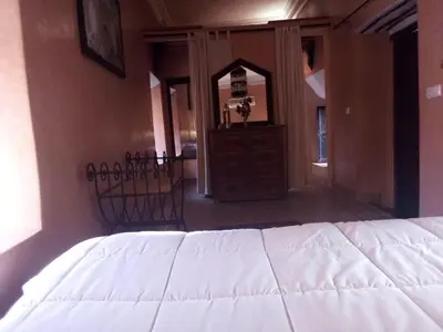 a bedroom with a white bed and a mirror at Riad Mina in Marrakech