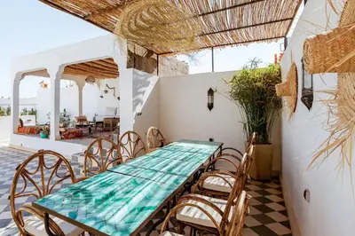 a dining room with a table and chairs at Riad Alkemia en exclusivité in Marrakech