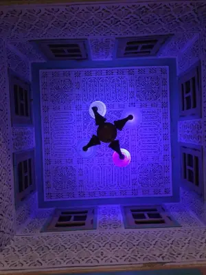 a teddy bear hanging from a purple ceiling at ALMARKAB Riad in Marrakech
