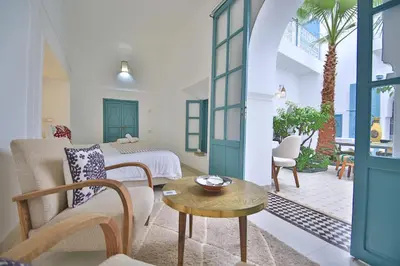 a living room with a bed and a table at Riad 5 GÉNÉRATIONS in Marrakech