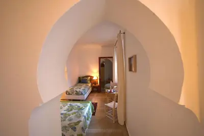 a living room with an archway and a couch in a room at Riad Aventurine in Marrakech