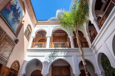 a palm tree in front of a building with a palm tree at Riad Agdal Royal & Spa in Marrakech