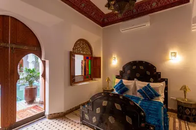 a bedroom with a couch and a mirror in a room at Riad Agdal Royal & Spa in Marrakech