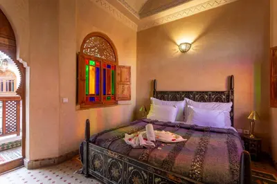 a bedroom with a bed with a tray on it at Riad Agdal Royal & Spa in Marrakech