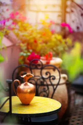 a tea pot sitting on a table with flowers at Riad Roxanne in Marrakech