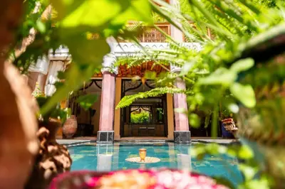 a courtyard with a fountain in front of a building at Riad Roxanne in Marrakech
