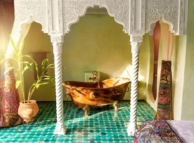 a bathroom with a wooden tub in a room at Riad Roxanne in Marrakech