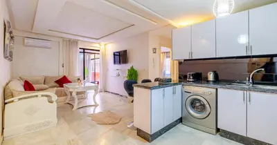 a kitchen and living room with a washing machine at AiM HOUSE in Marrakech