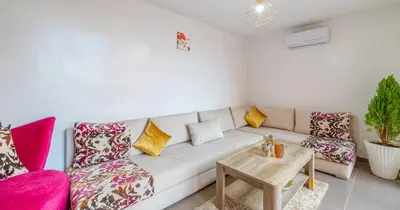 a living room with a couch and a table at AiM HOUSE in Marrakech