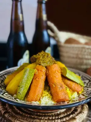 a plate of food with carrots and bananas on a table at Héritage Lalla Aicha Hotel & Spa in Marrakech