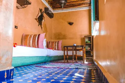 a bedroom with a bed and a table in a room at Héritage Lalla Aicha Hotel & Spa in Marrakech