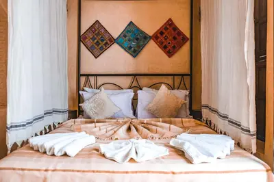 a bed with two white towels on top of it at Héritage Lalla Aicha Hotel & Spa in Marrakech