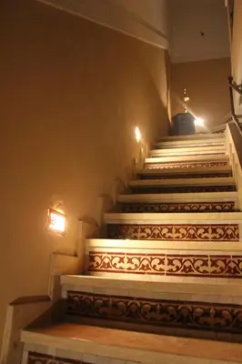 a set of stairs in a building with lights at Riad la medersa in Marrakech