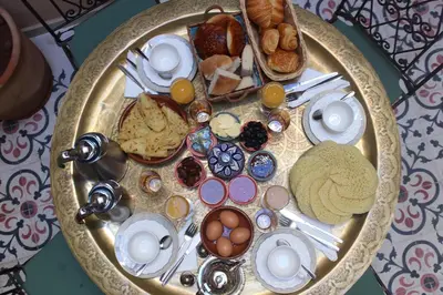 a breakfast plate with eggs and other foods on a table at Riad la medersa in Marrakech