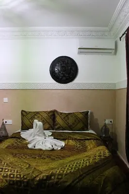 a bedroom with a bed with a towel on it at Riad la medersa in Marrakech