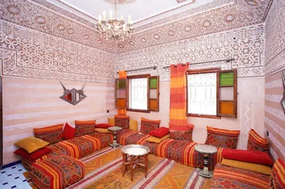 a living room with colorful furniture and a chandelier at Riad Dar Essassi 23 in Marrakech