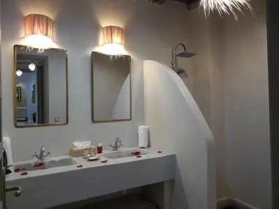 a bathroom with a sink and two mirrors at Riad et Spa Misria Les Oliviers in Marrakech