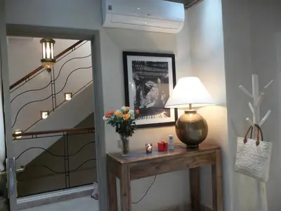 a hallway with a table with a lamp and a staircase at Riad et Spa Misria Les Oliviers in Marrakech