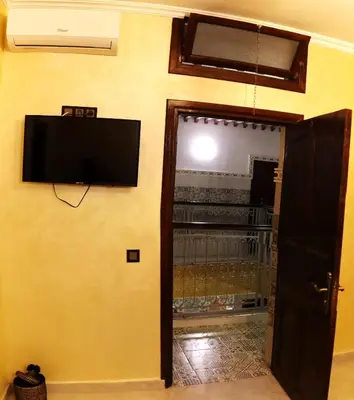 a room with a flat screen tv on the wall at Riad Rayan's Guests in Marrakech