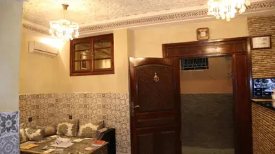 a living room with a couch and a table and a door at Riad Rayan's Guests in Marrakech
