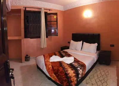 a hotel room with a bed with a bow on it at Riad Rayan's Guests in Marrakech