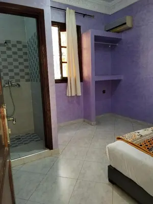 a purple bathroom with a shower and a bed at Riad Rayan's Guests in Marrakech