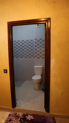 a bathroom with a toilet and a glass door at Riad Rayan's Guests in Marrakech