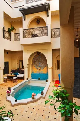 a large house with a swimming pool in a room at Riad Papillon by Marrakech Riad in Marrakech
