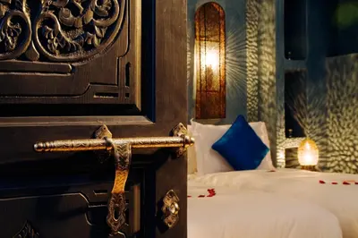 a room with two beds with a cross on the wall at Riad Cinnamon by Marrakech Riad in Marrakech