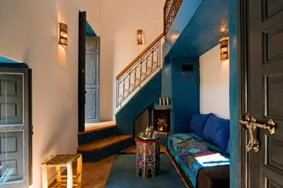 a room with a staircase and a bed and a door at Riad Cinnamon by Marrakech Riad in Marrakech
