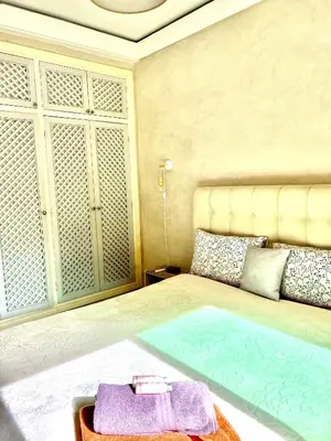 a bedroom with a large bed with towels on it at Comme à la maison, en plein coeur de Marrakech in Marrakech