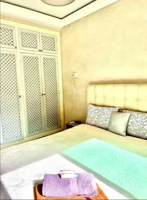 a bedroom with a large bed with towels on it at Comme à la maison, en plein coeur de Marrakech in Marrakech