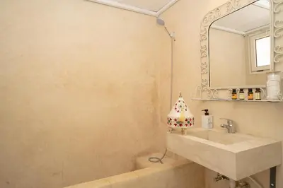 a bathroom with a sink and a mirror at Résidence alqaria assiyahiya full private riad in Marrakech