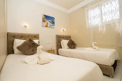 two beds in a room with two stuffed animals on them at Résidence alqaria assiyahiya full private riad in Marrakech
