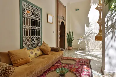 a living room with a couch and a table at Riad NaaNaa Bed & Breakfast in Marrakech