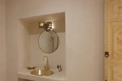 a bathroom with a sink and a mirror at Riad NaaNaa Bed & Breakfast in Marrakech