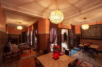 a living room with a table with flowers on it at Riad Khabia & Spa in Marrakech