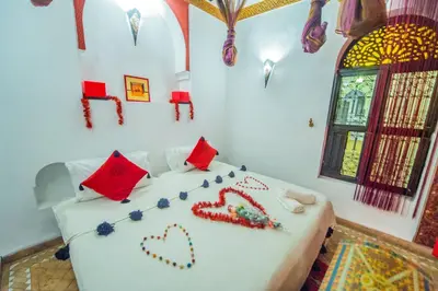 a bedroom with a bed with heart decorations on it at Riad Khabia & Spa in Marrakech