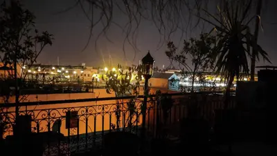 a fence in front of a city at night at Riad Hôtel Marraplace in Marrakech
