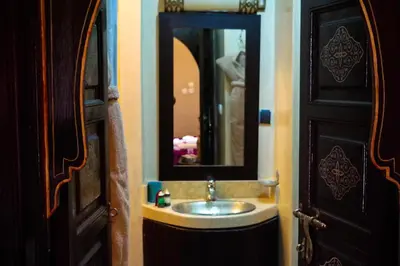 a bathroom with a sink and a mirror at Riad Hôtel Marraplace in Marrakech
