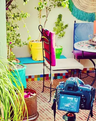 a camera in a room with plants and a table at Riad Eva in Marrakech